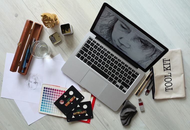 Creative flat lay with sketches, color chart and tools